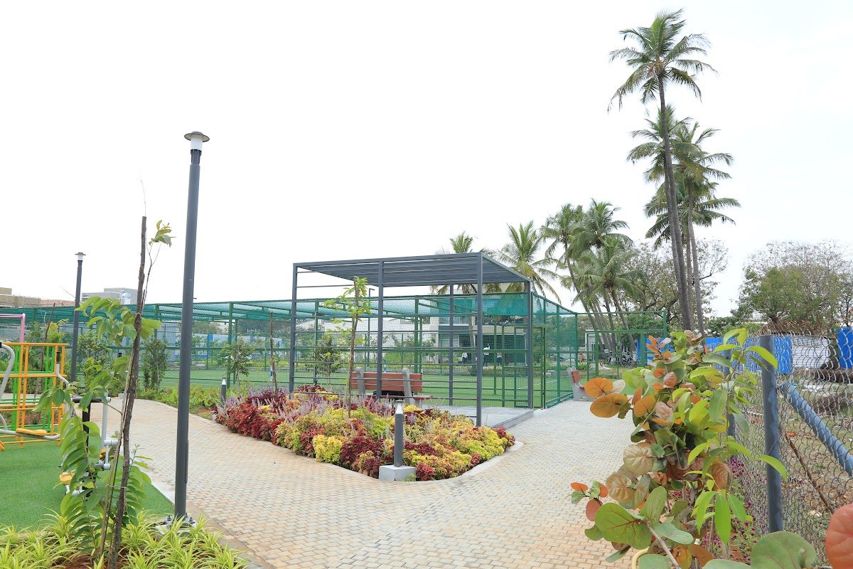 Paved garden pathway with pergola and colourful planting