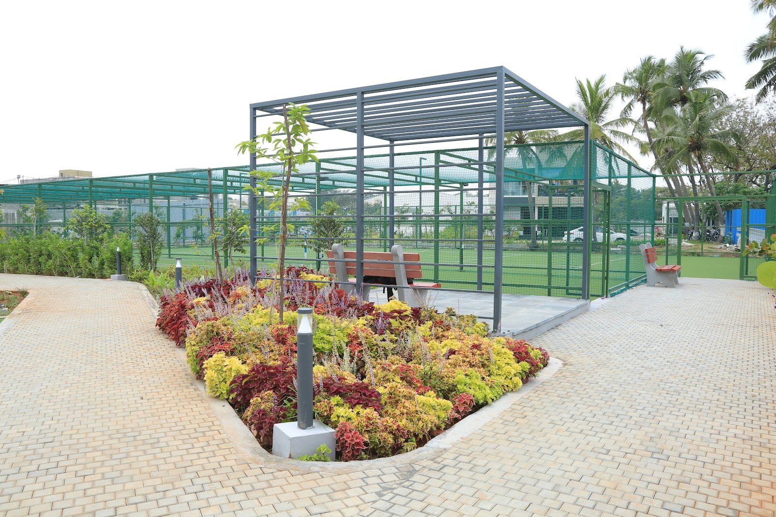 Pergola with paved pathway and colourful foliage planting beds