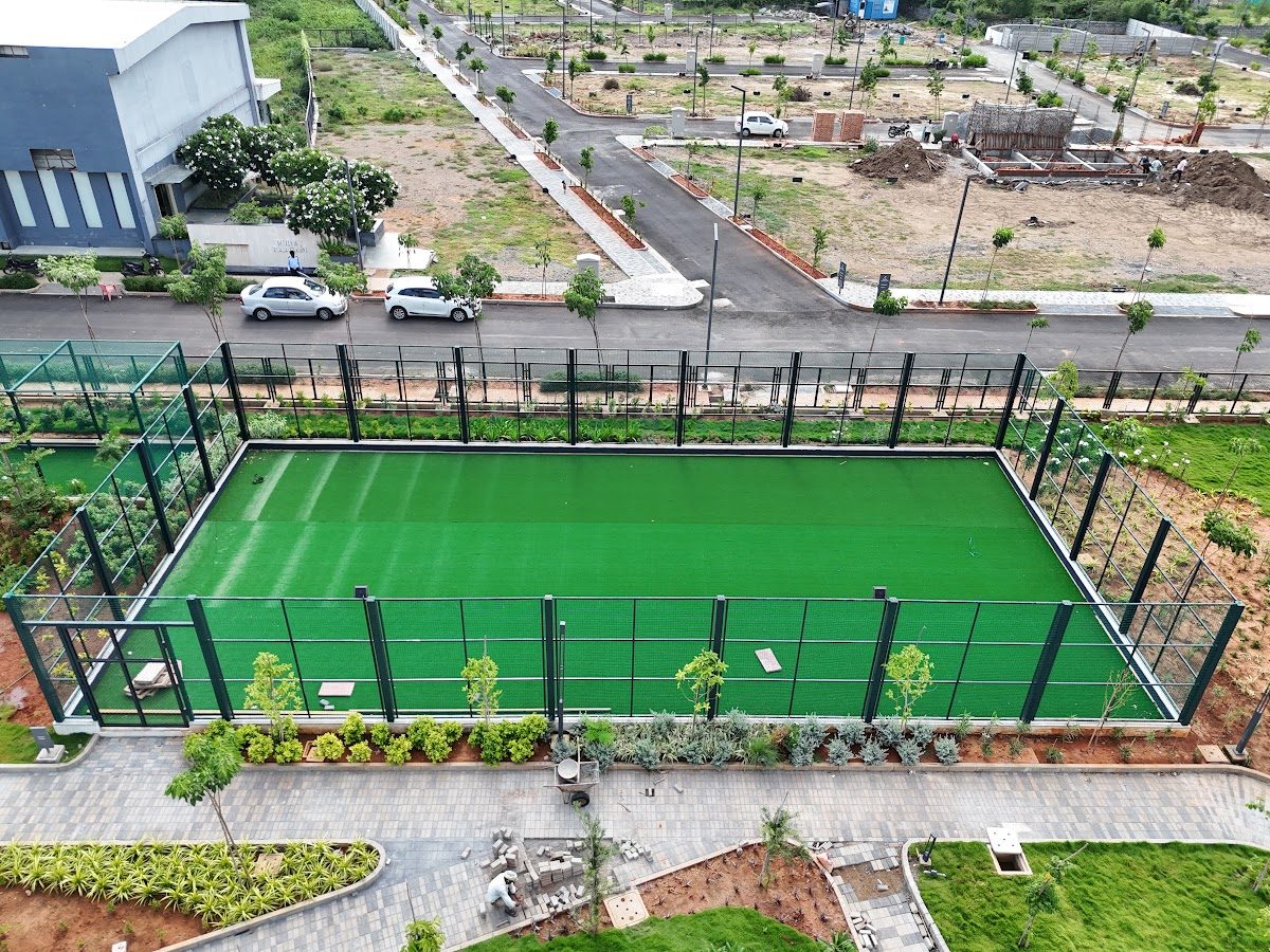 Green synthetic turf court enclosed by netting